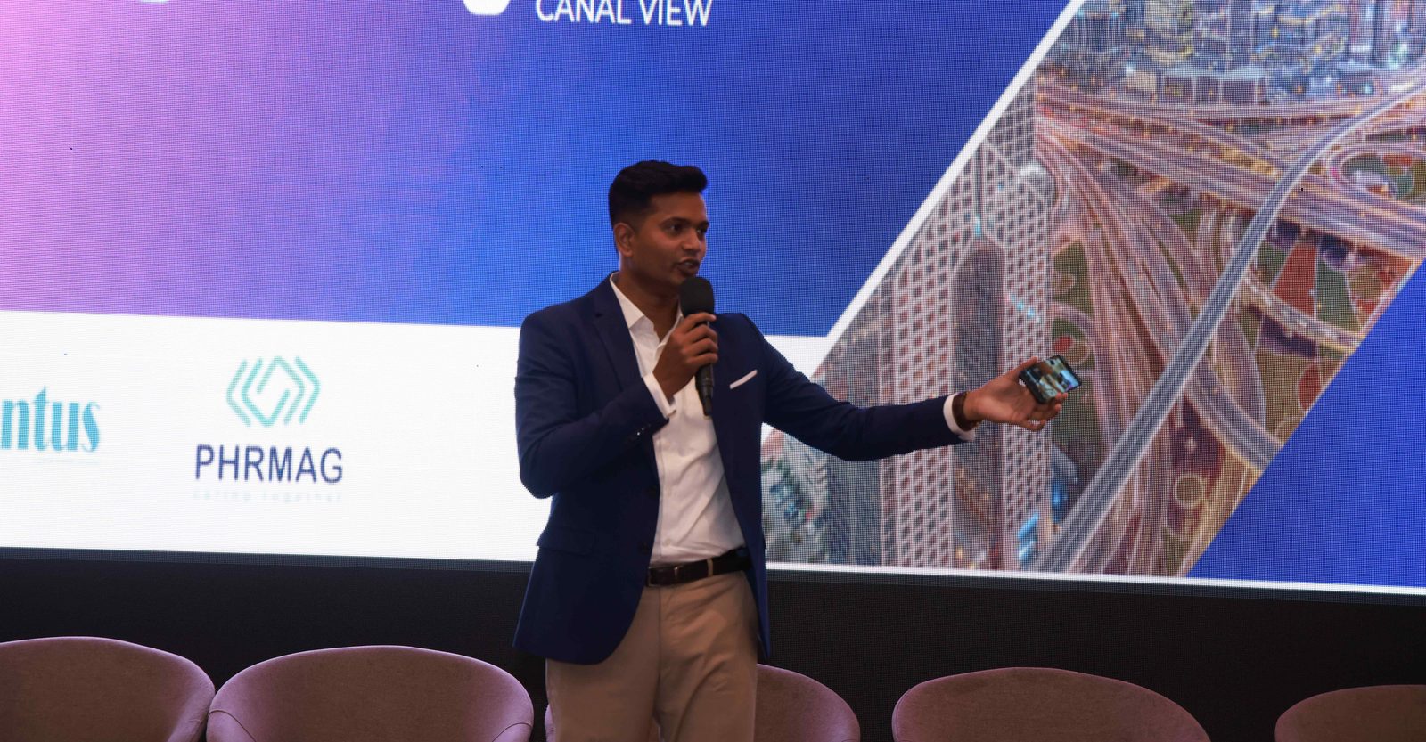 Samson speaking on stage at a leadership event